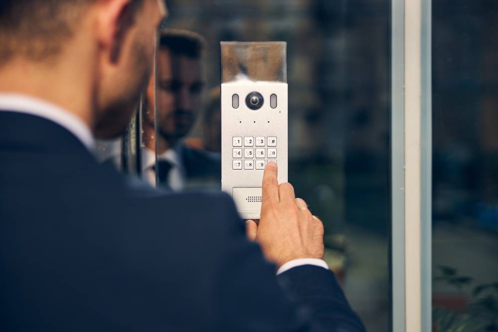 Electrified Access Control Young man trying to enter building touching buttons